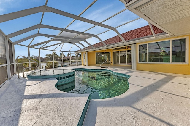 view of pool with a hot tub, a lanai, and a patio area