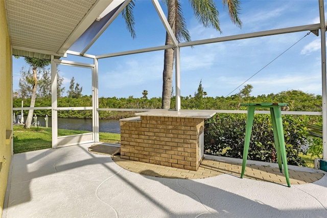 unfurnished sunroom featuring a water view