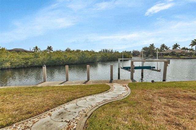 dock area featuring a lawn and a water view