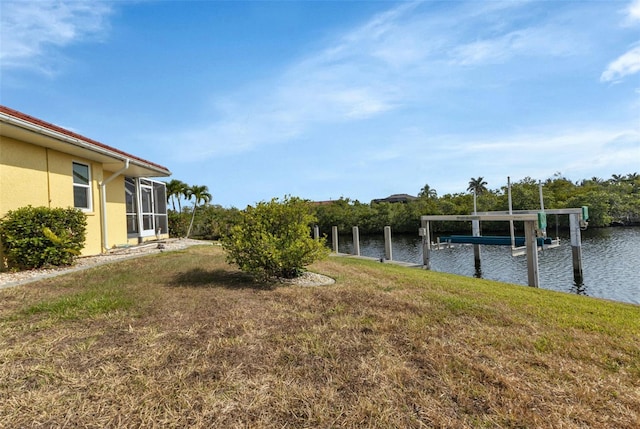 view of yard with a dock and a water view