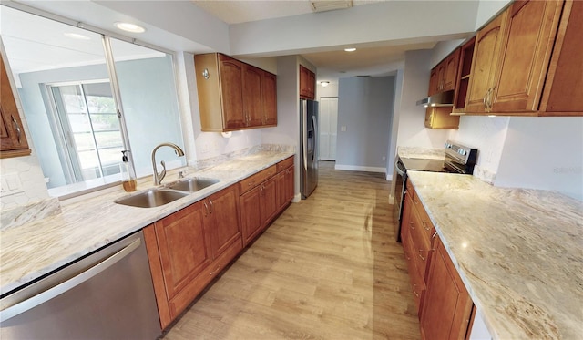 kitchen featuring light wood-type flooring, sink, and appliances with stainless steel finishes