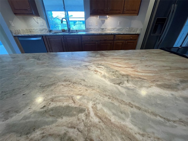 kitchen featuring stainless steel appliances, sink, and concrete flooring