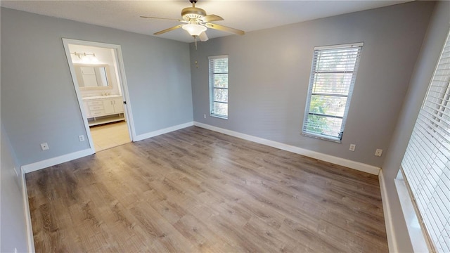 empty room featuring ceiling fan and light wood-type flooring