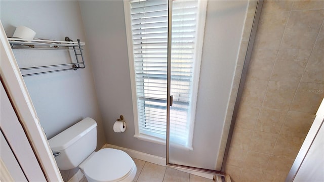 bathroom with a healthy amount of sunlight, toilet, an enclosed shower, and tile patterned floors