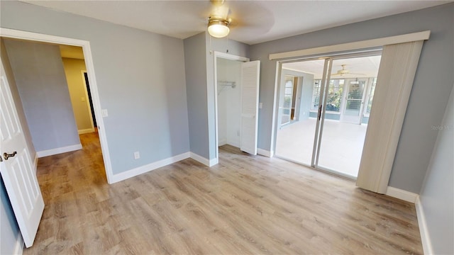 spare room with light wood-type flooring and ceiling fan