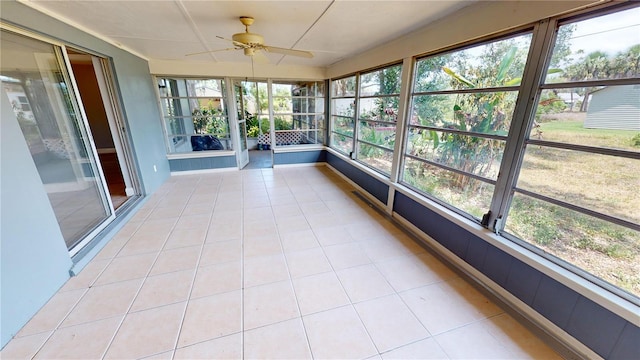 unfurnished sunroom with plenty of natural light and ceiling fan