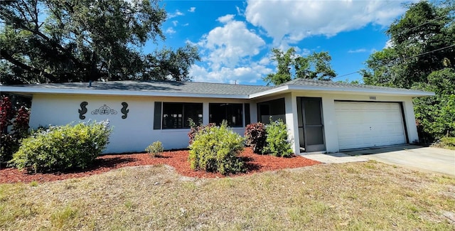 single story home with a front lawn and a garage