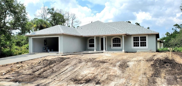 rear view of property featuring a garage