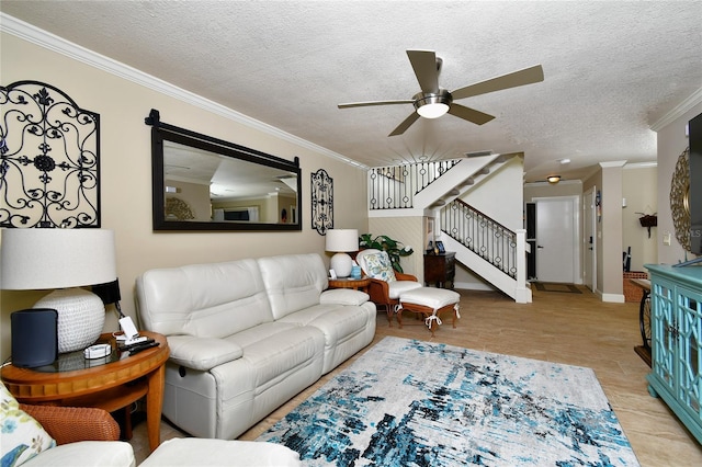 living room featuring a textured ceiling, ornamental molding, and ceiling fan