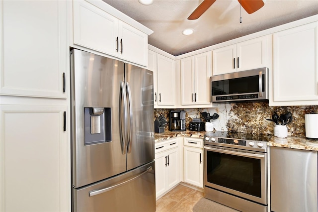 kitchen featuring ceiling fan, tasteful backsplash, light tile flooring, light stone counters, and appliances with stainless steel finishes