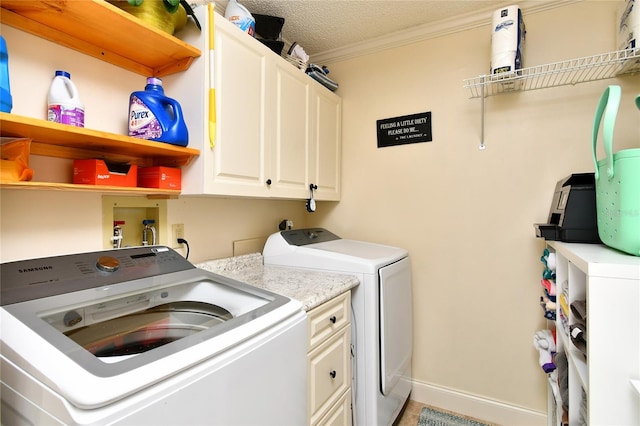 laundry area with cabinets, washer and clothes dryer, ornamental molding, hookup for a washing machine, and a textured ceiling