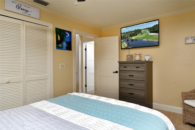 tiled bedroom with a closet, a textured ceiling, and crown molding