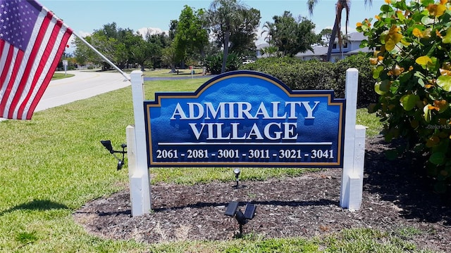 community / neighborhood sign with a lawn