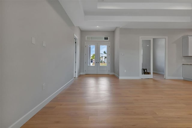 entryway with light hardwood / wood-style floors and french doors