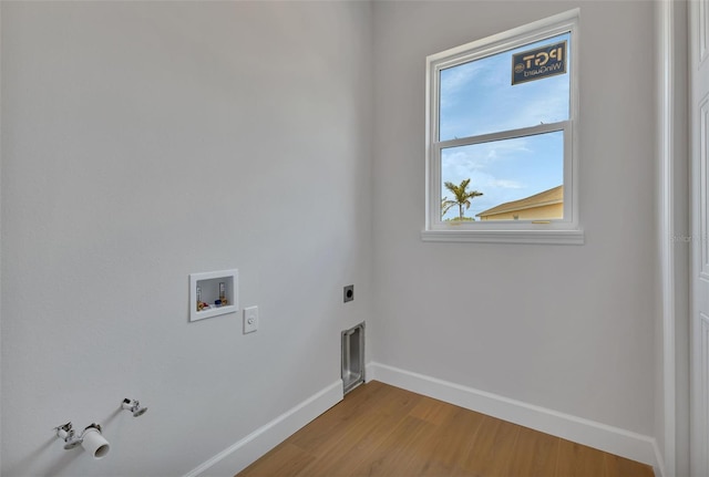 washroom with washer hookup, hardwood / wood-style flooring, electric dryer hookup, and gas dryer hookup