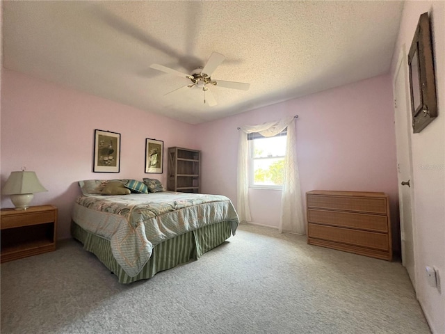 carpeted bedroom with a textured ceiling and ceiling fan