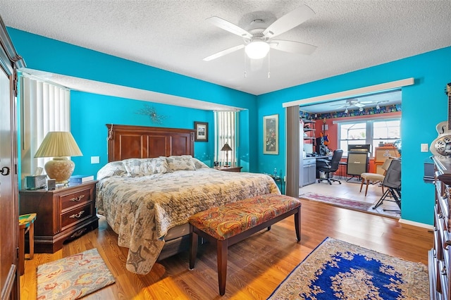 bedroom featuring wood-type flooring, a textured ceiling, and ceiling fan