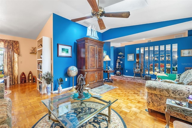 living room featuring ceiling fan, vaulted ceiling, and parquet flooring