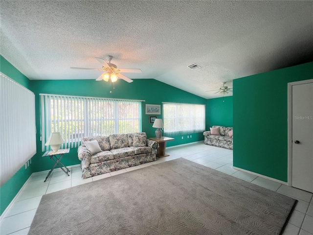 tiled living room featuring lofted ceiling, a textured ceiling, and ceiling fan