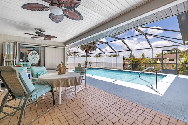 view of swimming pool featuring ceiling fan, a lanai, outdoor lounge area, and a patio area