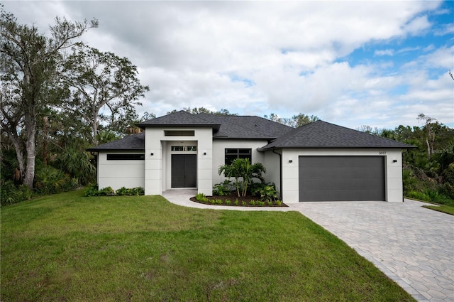 view of front of home with a garage and a front yard