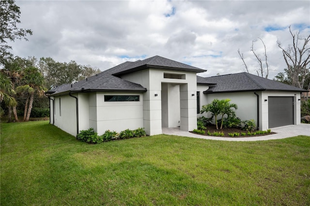 prairie-style house featuring a front lawn and a garage