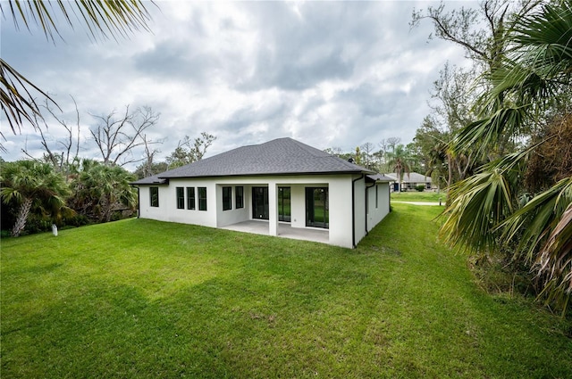 back of house with a patio and a yard