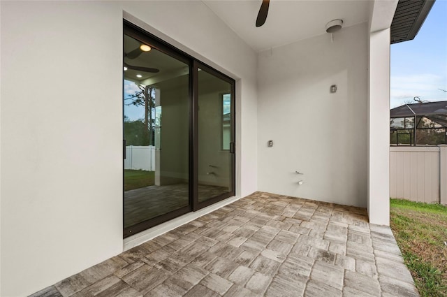 view of patio / terrace featuring ceiling fan and a lanai