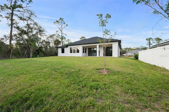 rear view of house with a yard