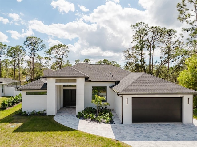 view of front of property featuring a garage and a front yard