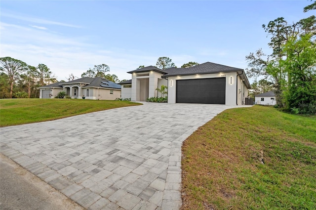 view of front of house with a garage and a front lawn