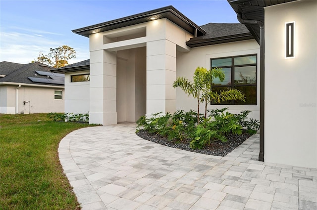 doorway to property featuring a lawn