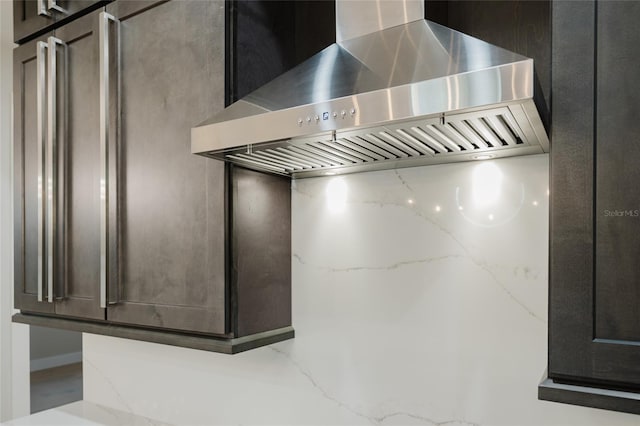 interior details featuring light stone counters and exhaust hood