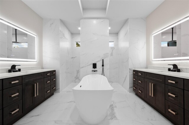 bathroom with vanity and a tub to relax in