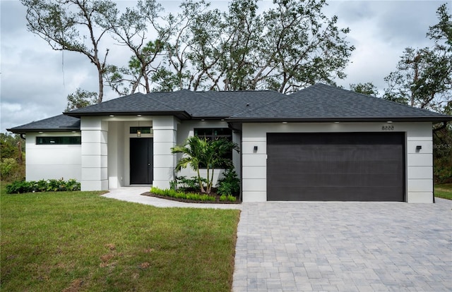 view of front of property with a garage and a front yard