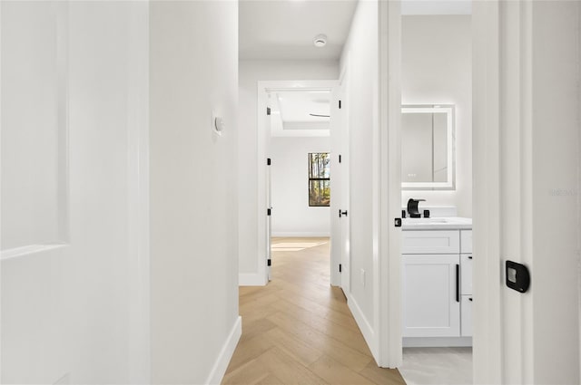 hall with sink and light parquet floors