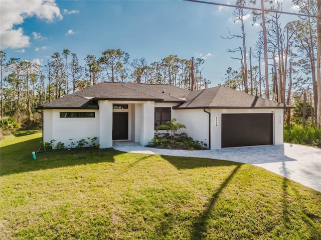 view of front of house with a garage and a front lawn