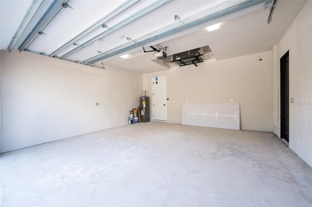 garage featuring a garage door opener and electric water heater