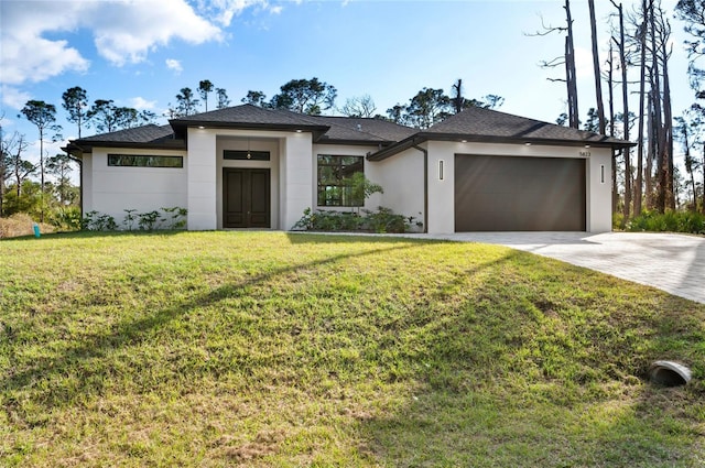 view of front facade with a garage and a front yard