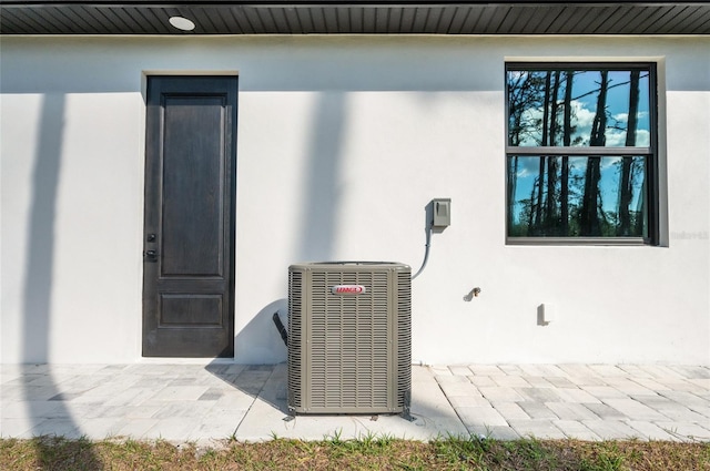 doorway to property with a patio and central air condition unit