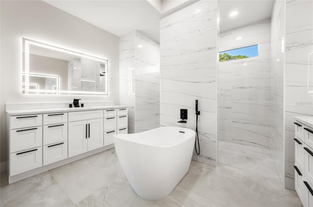 bathroom with vanity, shower with separate bathtub, and tile walls