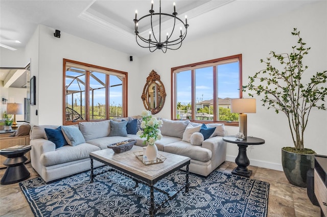 living room featuring a tray ceiling and an inviting chandelier