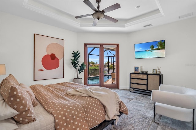 bedroom featuring access to exterior, french doors, a raised ceiling, and ceiling fan