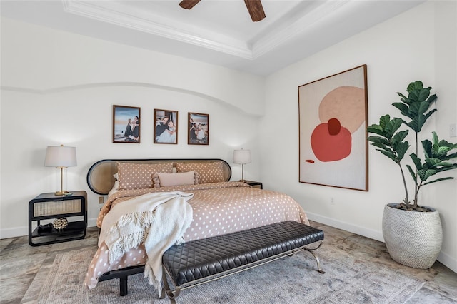 bedroom with ceiling fan, ornamental molding, and a tray ceiling