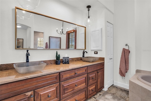 bathroom featuring tiled bath, vanity, and a chandelier