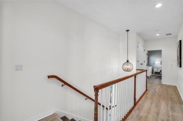 corridor with light hardwood / wood-style flooring