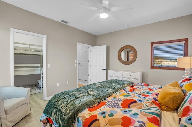 bedroom featuring a closet, light hardwood / wood-style flooring, and ceiling fan