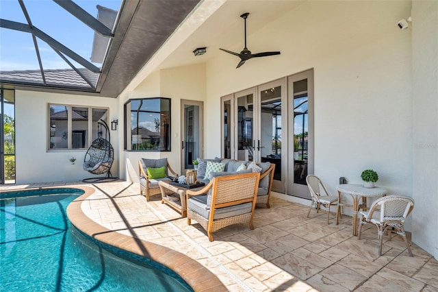 view of swimming pool with an outdoor living space, french doors, ceiling fan, a lanai, and a patio area