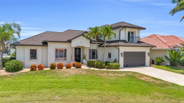 mediterranean / spanish house with a balcony, a front lawn, and a garage