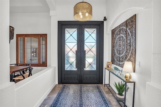 foyer with dark hardwood / wood-style flooring and french doors